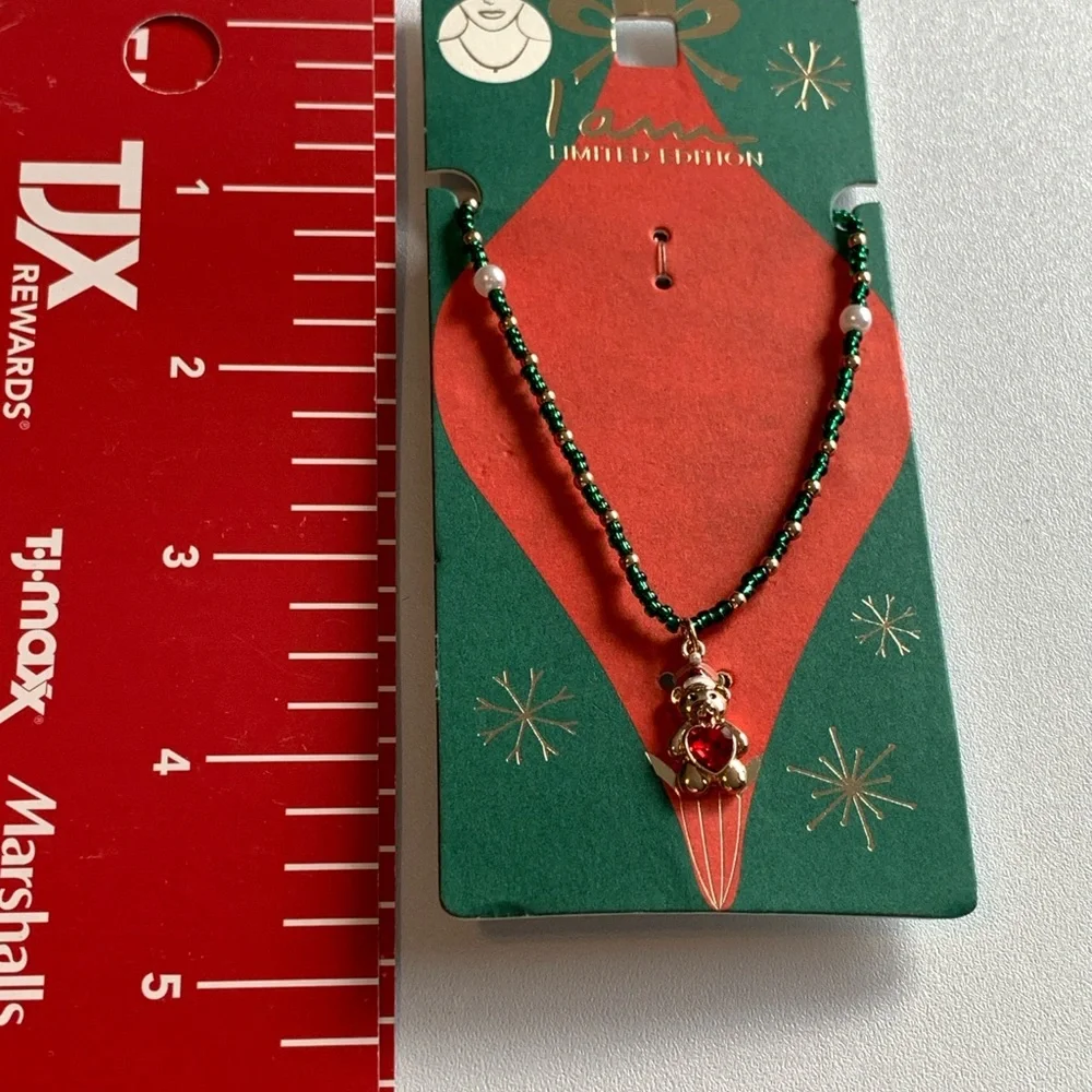 Sweet little Christmas bear necklace with red heart belly.